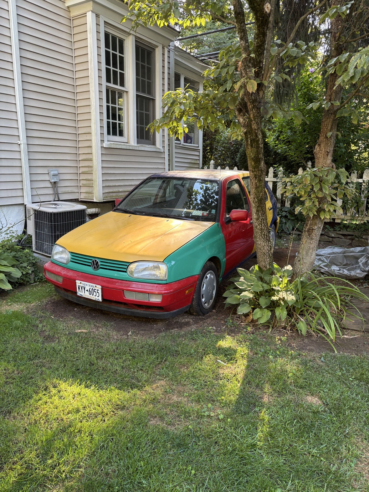 1996 Volkswagen Golf Harlequin parked at home beneath the trees