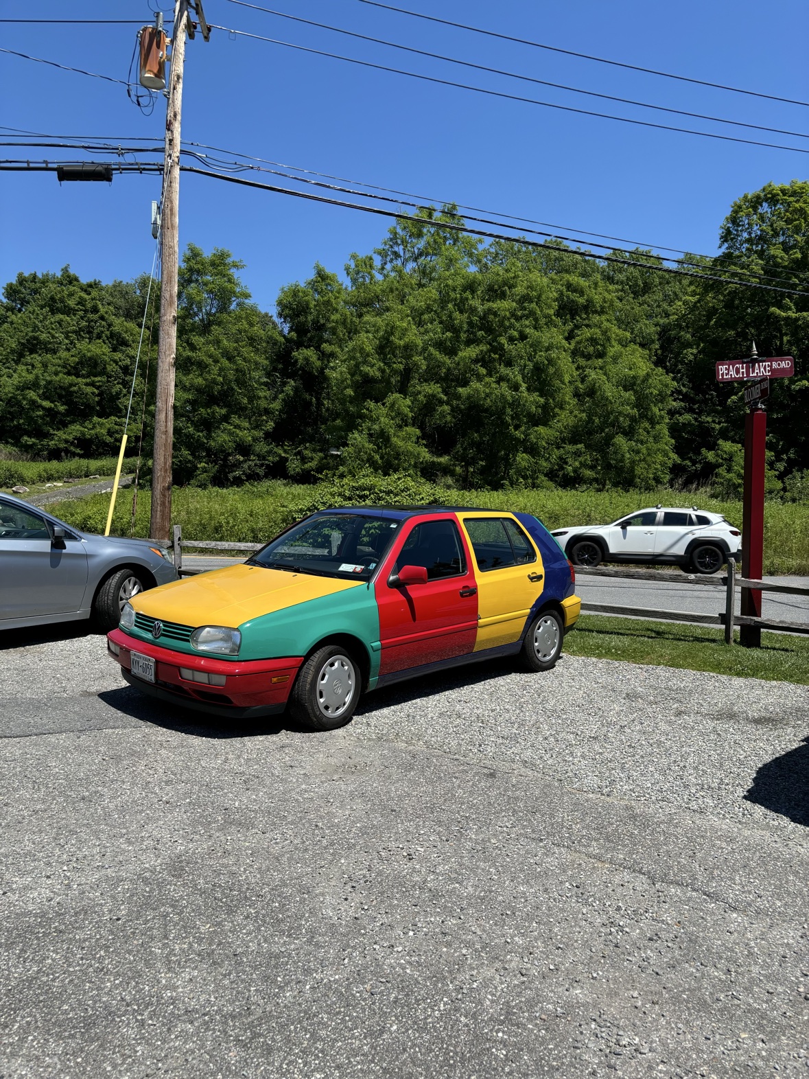 1996 Volkswagen Golf Harlequin parked beside the road on a clear summer day