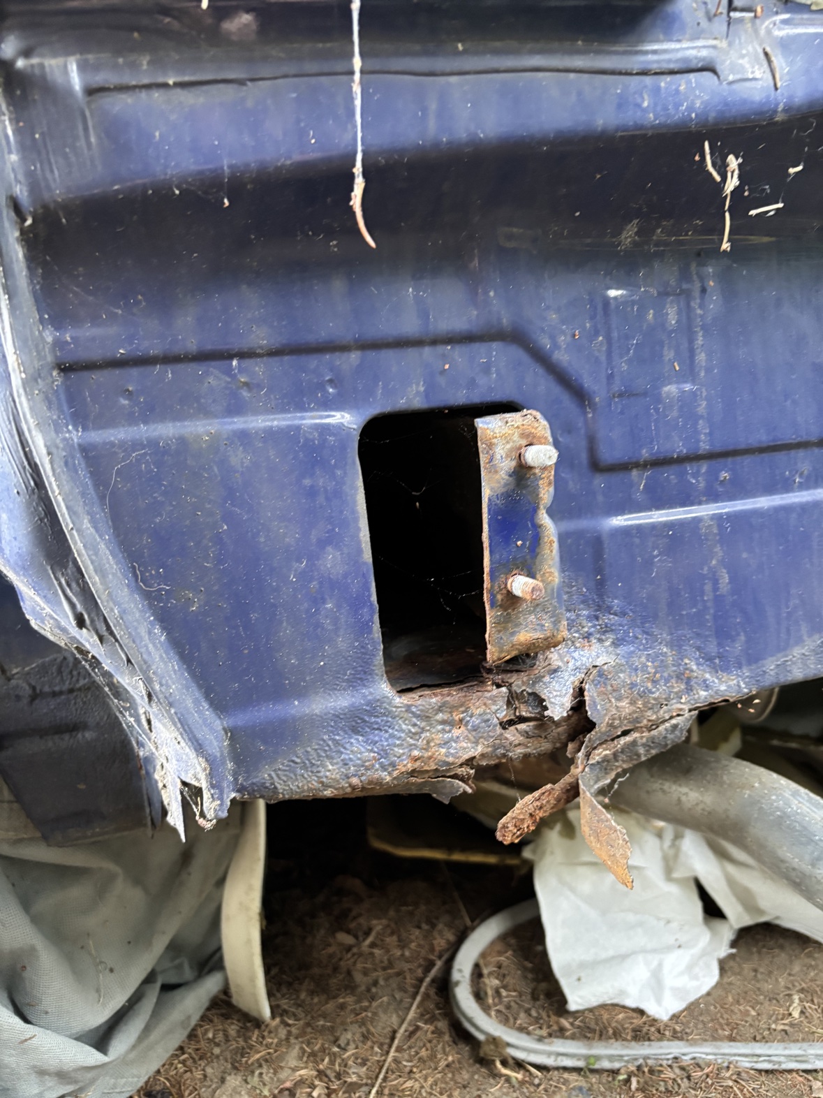 Rust hole exposed in the Harlequin bodywork