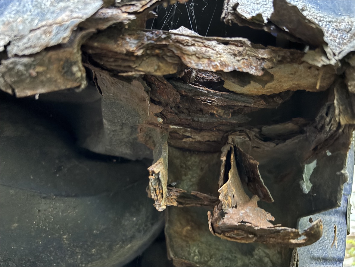 Close view of severe layered rust beneath the Harlequin